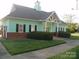 Community clubhouse is well manicured with green grass, shrubs, and has a sidewalk at 1960 Aston Mill Pl, Charlotte, NC 28273