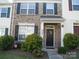 Charming two-story townhome with brick facade, black shutters, and a well-manicured front yard at 1960 Aston Mill Pl, Charlotte, NC 28273