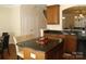 Modern kitchen island with granite countertops, dark cabinets and stainless steel appliances at 1960 Aston Mill Pl, Charlotte, NC 28273