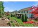 Spacious backyard with a stone patio, pergola, and lush landscaping at 2002 Thurston Dr, Indian Trail, NC 28079