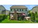Exterior view of a home with a stone patio, outdoor kitchen, and well-maintained lawn at 2002 Thurston Dr, Indian Trail, NC 28079