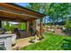 Backyard with a covered patio with fireplace and a meticulously maintained lawn at 2002 Thurston Dr, Indian Trail, NC 28079