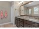 Bathroom featuring double sinks with granite countertops and a framed mirror at 2002 Thurston Dr, Indian Trail, NC 28079