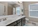 A spacious bathroom features dual sinks and a shower with tile walls at 2002 Thurston Dr, Indian Trail, NC 28079