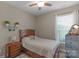 Comfortable bedroom features a ceiling fan, matching nightstand and chest of drawers at 2002 Thurston Dr, Indian Trail, NC 28079