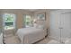 Bright bedroom featuring two windows with curtains, a closet and a comfortable bed at 2002 Thurston Dr, Indian Trail, NC 28079