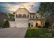 Charming two-story home with a three-car garage and well-manicured lawn and front garden at 2002 Thurston Dr, Indian Trail, NC 28079