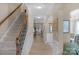 Inviting hallway with staircase, hardwood floors, and elegant trim, leading to open living spaces at 2002 Thurston Dr, Indian Trail, NC 28079