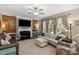 Comfortable living room featuring a fireplace with white mantel, wood accent wall, and neutral decor at 2002 Thurston Dr, Indian Trail, NC 28079