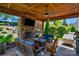 Inviting outdoor space with stone fireplace, TV and comfortable seating at 2002 Thurston Dr, Indian Trail, NC 28079