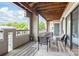 Spacious covered balcony with outdoor seating, wood flooring, and a view of the surrounding trees at 212 W 10Th St # 17, Charlotte, NC 28202
