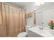 Cozy bathroom with decorative shower curtain, gray vanity, and ample lighting at 212 W 10Th St # 17, Charlotte, NC 28202