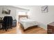 Inviting bedroom featuring hardwood floors, a bed, and a desk; perfect for comfort and productivity at 212 W 10Th St # 17, Charlotte, NC 28202