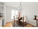 Dining area with round glass table, four chairs and natural light, next to hardwood flooring at 212 W 10Th St # 17, Charlotte, NC 28202
