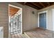 Welcoming entrance with a wooden deck, gate access to the patio, and a blue front door at 212 W 10Th St # 17, Charlotte, NC 28202