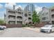 Condo complex exterior with balconies, lush landscaping, well-maintained facade, and parking spaces at 212 W 10Th St # 17, Charlotte, NC 28202