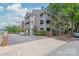 Multi-level building with gray siding, balconies, and mature trees in a convenient location at 212 W 10Th St # 17, Charlotte, NC 28202