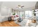 Living room with hardwood floors, sliding doors to balcony, ceiling fan and comfortable seating at 212 W 10Th St # 17, Charlotte, NC 28202