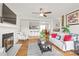 Open-concept living space with hardwood floors, a fireplace, and view of the kitchen and dining areas at 212 W 10Th St # 17, Charlotte, NC 28202