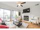 Bright living room with fireplace and sliding glass doors to the balcony, open living space at 212 W 10Th St # 17, Charlotte, NC 28202