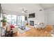 Bright living room with hardwood floors, fireplace, ceiling fan, sliding glass doors to balcony, and comfortable seating at 212 W 10Th St # 17, Charlotte, NC 28202