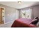 A calm bedroom painted grey, and featuring an exterior view through the bright window at 221 Sycamore Creek Rd, Fort Mill, SC 29708