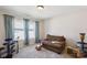 Neutral bedroom featuring plush carpet, a window, sofa, and musical instruments at 221 Sycamore Creek Rd, Fort Mill, SC 29708
