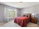 Bedroom featuring a window with curtains, a wood nightstand and a colorful comforter at 221 Sycamore Creek Rd, Fort Mill, SC 29708