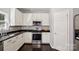Beautiful kitchen has modern appliances, black countertops, and updated cabinets and backsplash at 221 Sycamore Creek Rd, Fort Mill, SC 29708