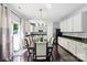 Open concept kitchen and dining area with modern appliances, dark countertops, and access to outdoor area at 221 Sycamore Creek Rd, Fort Mill, SC 29708