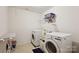 A laundry room featuring a washer, a dryer, an ironing board and metal shelving at 221 Sycamore Creek Rd, Fort Mill, SC 29708
