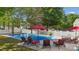 Beautiful backyard pool surrounded by lounge chairs, a picnic table, and a white picket fence at 221 Sycamore Creek Rd, Fort Mill, SC 29708
