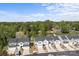 Aerial view of a community with houses, driveways, landscaping, and surrounding green trees at 2340 Belterra Dr, Charlotte, NC 28216