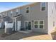 Exterior of home, view of back patio with table and chairs, sliding glass door, and neutral siding at 2340 Belterra Dr, Charlotte, NC 28216