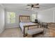 Comfortable bedroom features a bed, two windows, and a ceiling fan at 2340 Belterra Dr, Charlotte, NC 28216