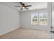 Bright bedroom features a ceiling fan, neutral walls, and two windows at 2340 Belterra Dr, Charlotte, NC 28216