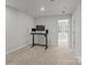 Bright office space featuring modern desk setup and neutral walls is well-lit by a ceiling light at 2340 Belterra Dr, Charlotte, NC 28216