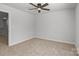 Cozy bedroom features a ceiling fan, neutral walls, and a large window at 2340 Belterra Dr, Charlotte, NC 28216