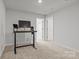 An office space featuring a modern desk setup and neutral walls is well-lit by a ceiling light at 2340 Belterra Dr, Charlotte, NC 28216