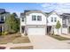 Inviting two-story townhome with a white garage door, gray accents, and a well-maintained front yard at 2340 Belterra Dr, Charlotte, NC 28216