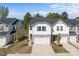 Charming two-story townhome showcases a white exterior, gray accents, and an attached white garage at 2340 Belterra Dr, Charlotte, NC 28216