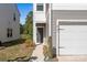 Welcoming front door with gray accents, complemented by the adjacent garage of this two-story townhome at 2340 Belterra Dr, Charlotte, NC 28216