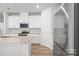 Bright kitchen featuring stainless appliances and granite countertops with white cabinets at 2340 Belterra Dr, Charlotte, NC 28216