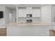 Stunning kitchen island featuring granite countertops, white cabinetry, and stainless steel appliances at 2340 Belterra Dr, Charlotte, NC 28216