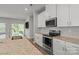 Open kitchen with stainless steel appliances, granite counters, and seamless access to outdoor living at 2340 Belterra Dr, Charlotte, NC 28216
