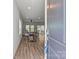 Open-concept living space featuring modern wood floors, recessed lighting, and neutral-toned furniture at 2340 Belterra Dr, Charlotte, NC 28216