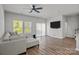 Living room featuring hardwood floors, ceiling fan, and sliding door to exterior at 2340 Belterra Dr, Charlotte, NC 28216