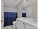Bathroom with double vanity, toilet, and shower/tub combination with blue curtain at 237 Walnut Point Dr, Matthews, NC 28105