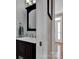 Bathroom featuring a vanity with dark cabinets, mirror, and updated faucet fixtures at 237 Walnut Point Dr, Matthews, NC 28105
