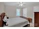 Cozy bedroom featuring a large window, closet, lamp, and neutral colored walls at 237 Walnut Point Dr, Matthews, NC 28105